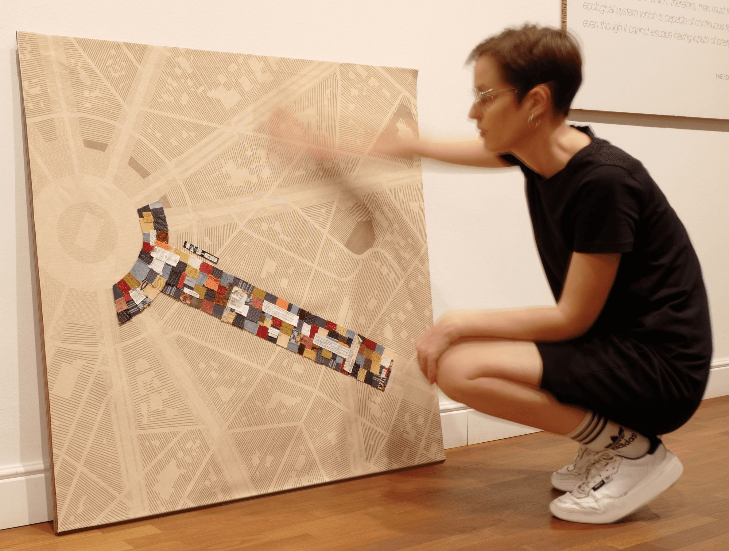 Textile data artwork visualizing fast fashion waste through a patchwork of used clothing scraps