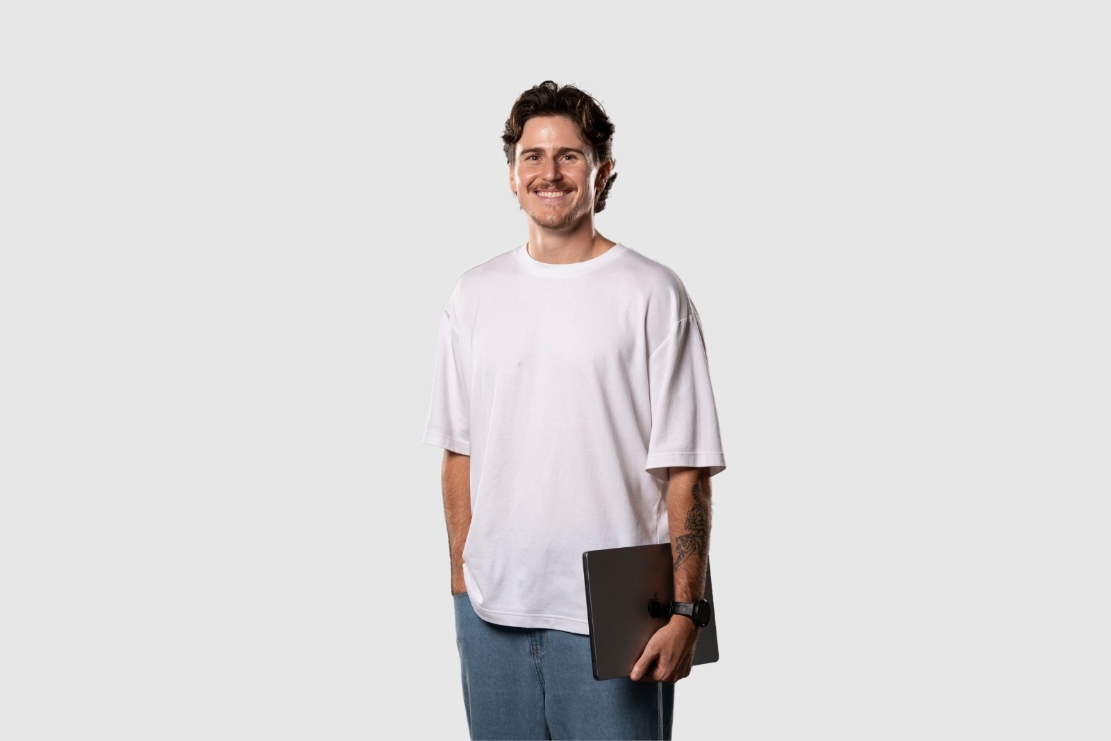 Bailey standing holding laptop