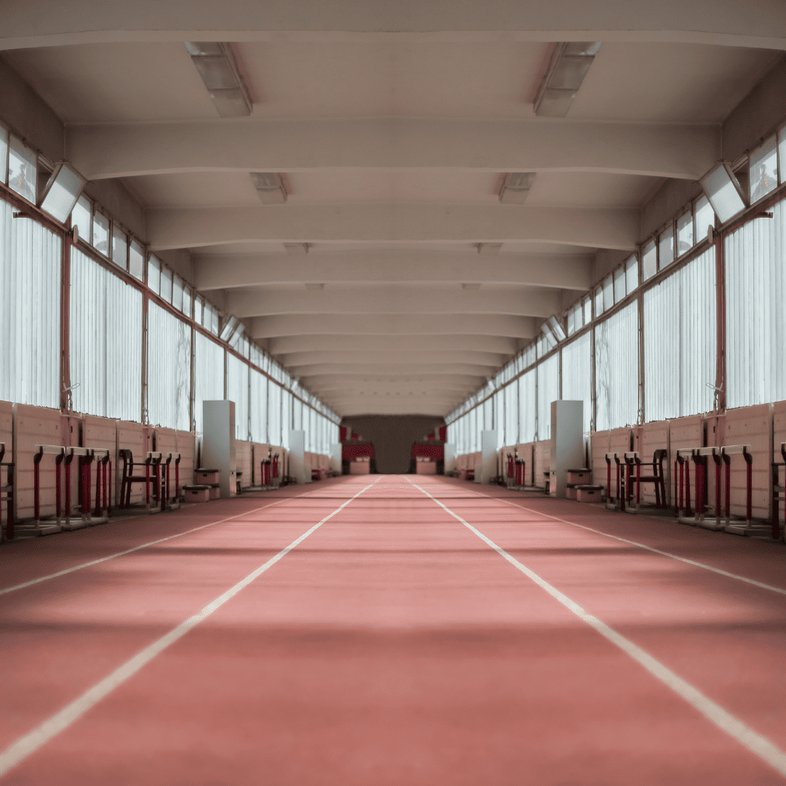 Indoor running track inside a training facility showing straightaway lanes used for indoor track events