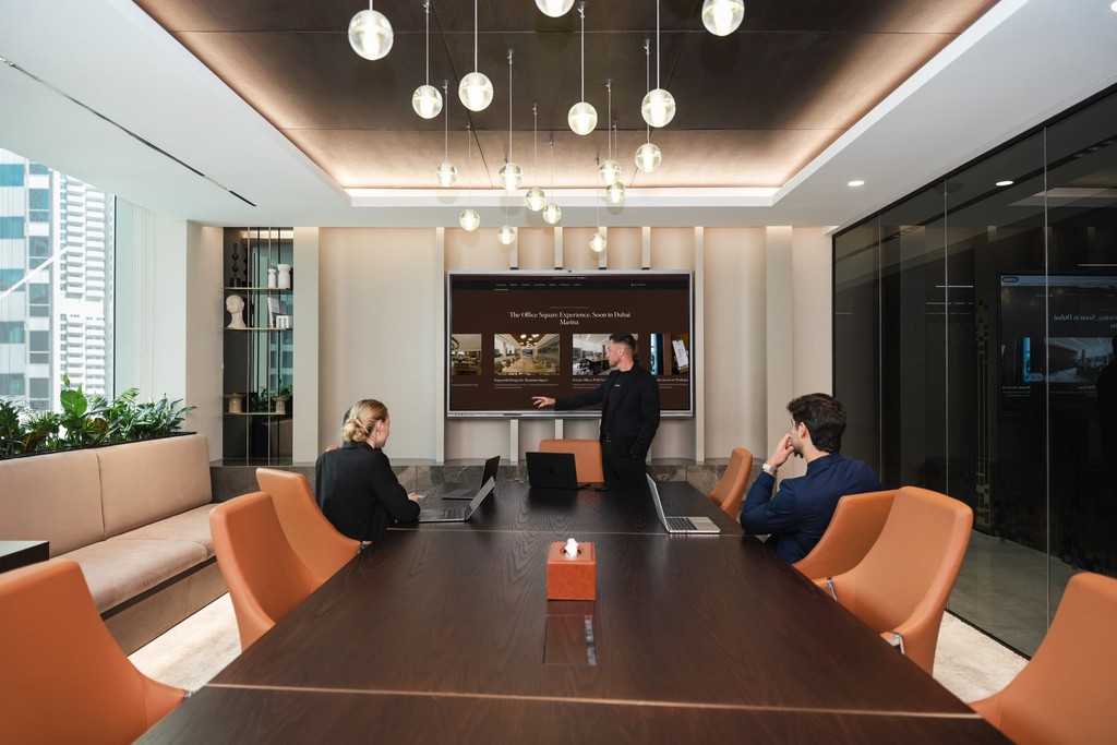 Modern executive meeting room in Dubai Marina with a large screen and conference table