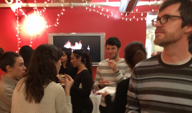 a group of people is having a snack in an exhibition room