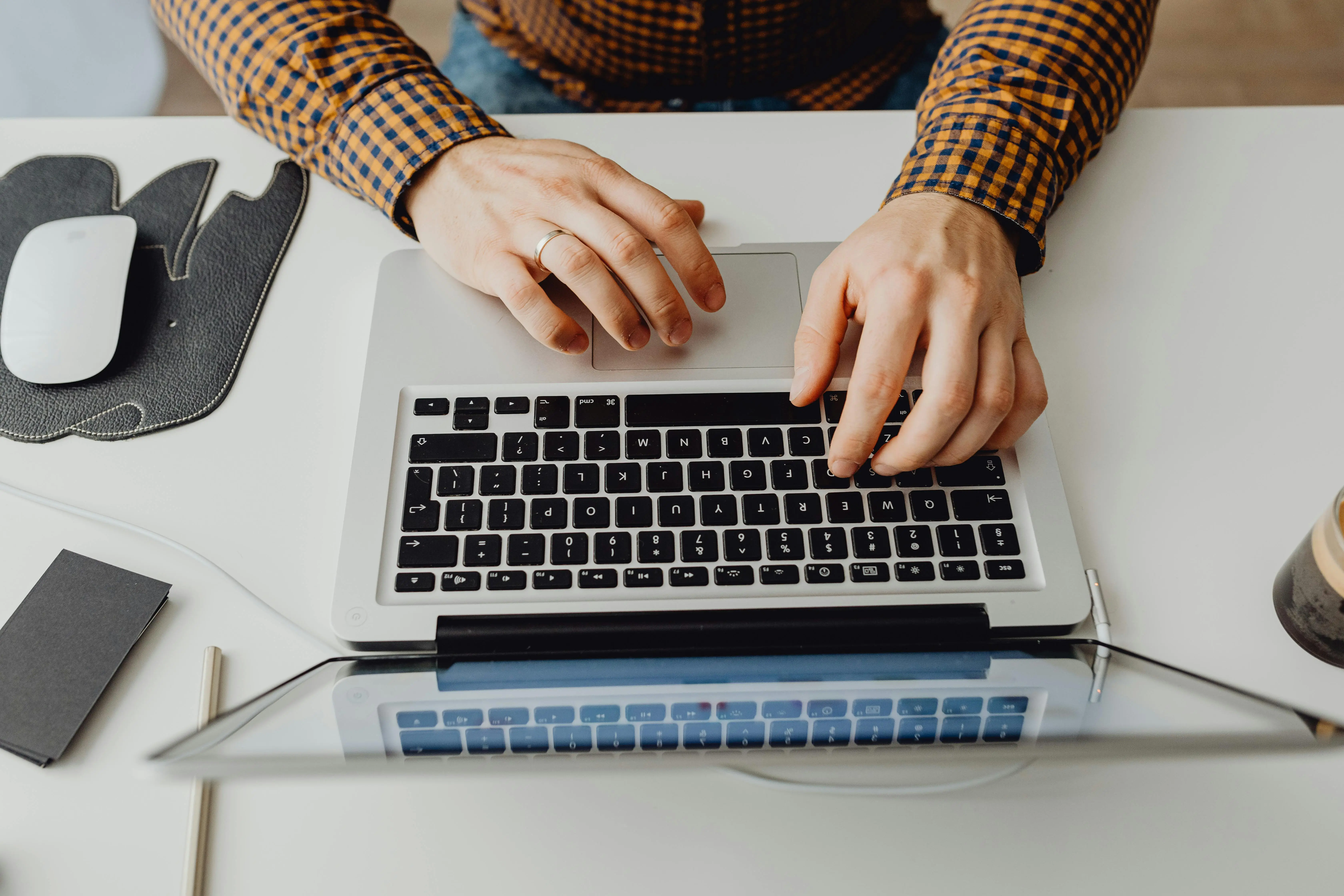 person working on a laptop. Image from pexels-karola-g showing someone writing a science fair abstract