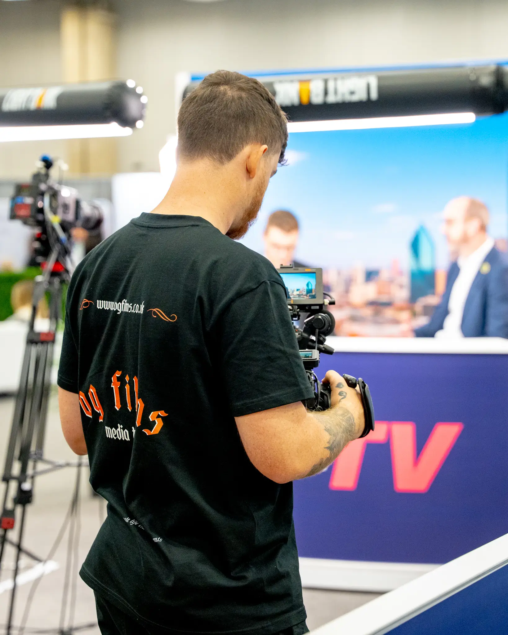 Portrait of a person in a pink sweater against a light background