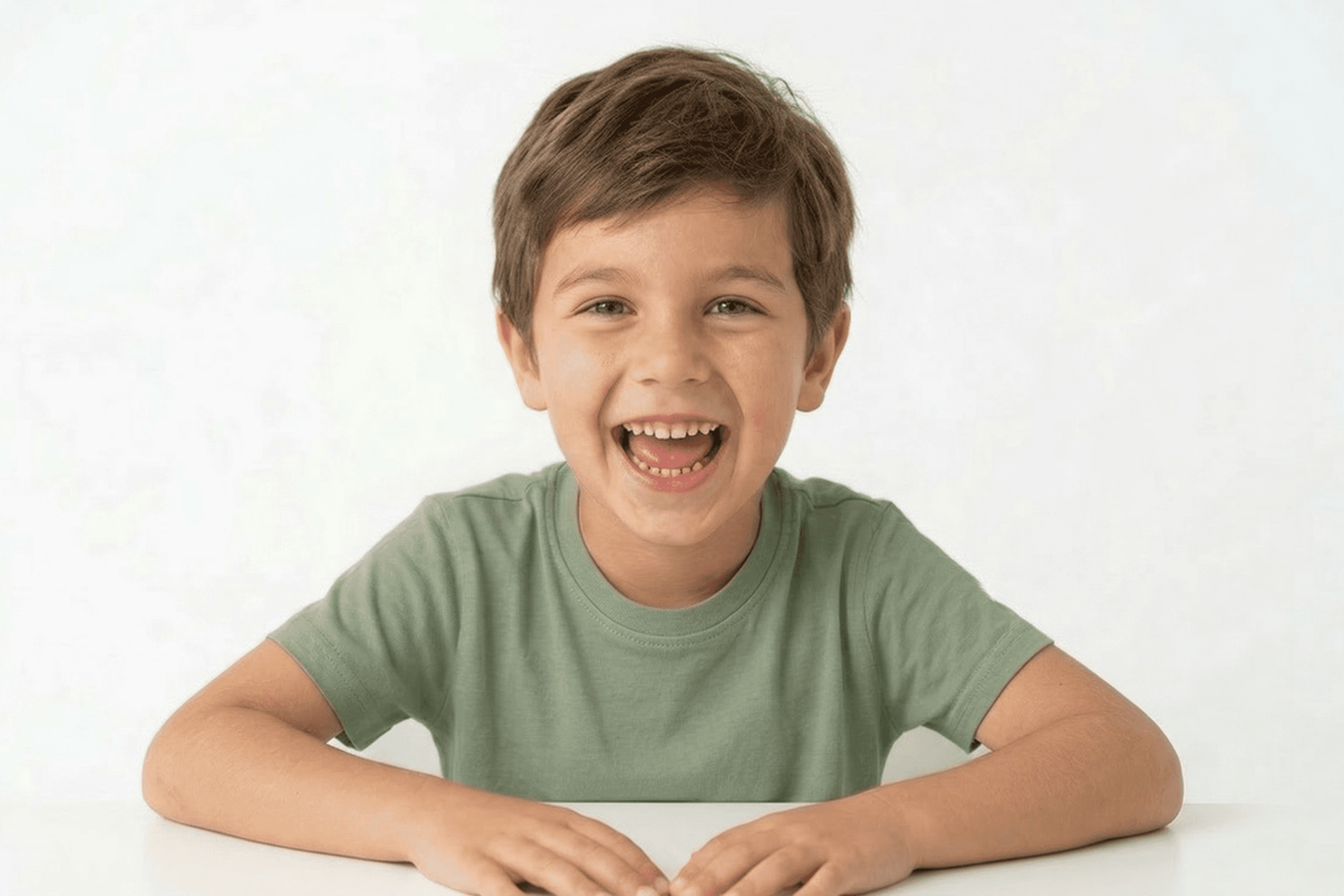 A young boy laughing with a wide-open smile, highlighting the comfortable environment for children in Bolton.