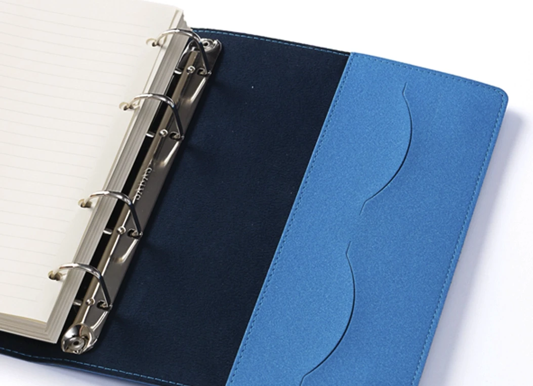 Close-up of inner cover pocket and metal ring binding in journal