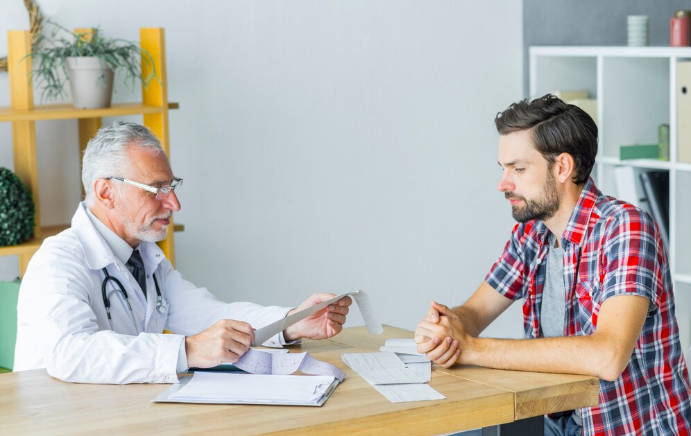 A senior doctor consulting and viewing reports of his patient.