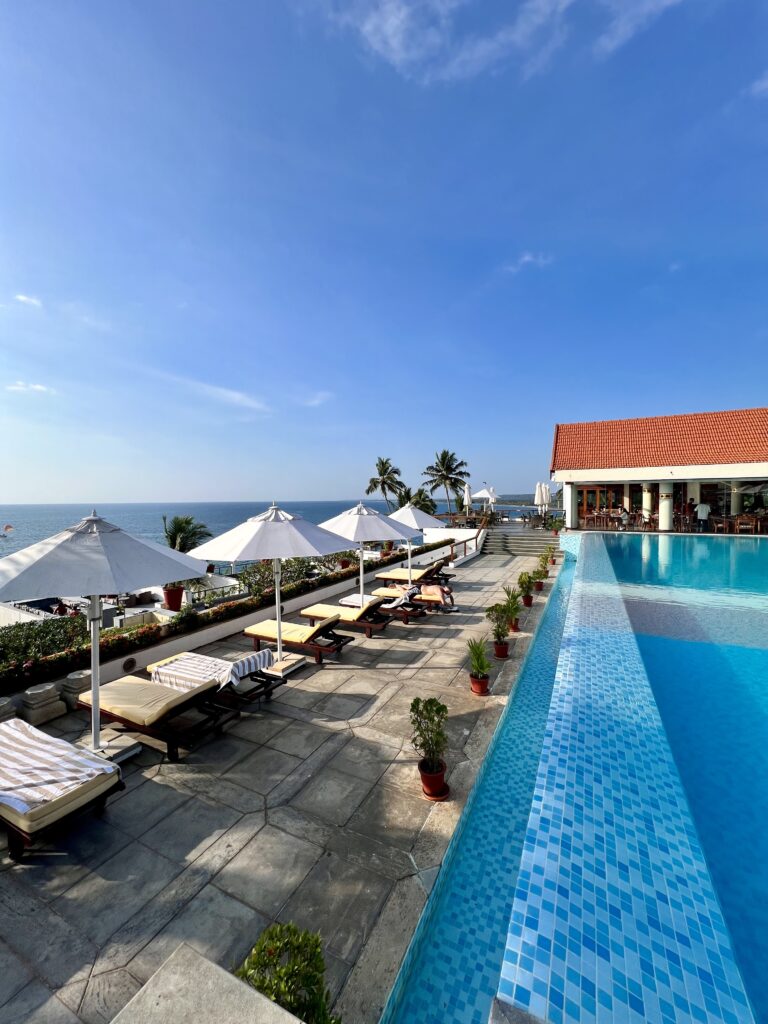 The main pool at Leela Kovalam overlooking the sea.