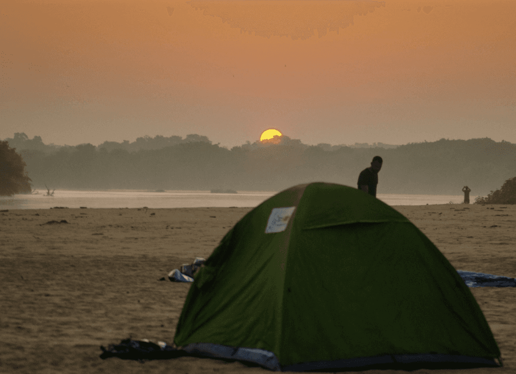 a group of women standing on top of a sandy beach