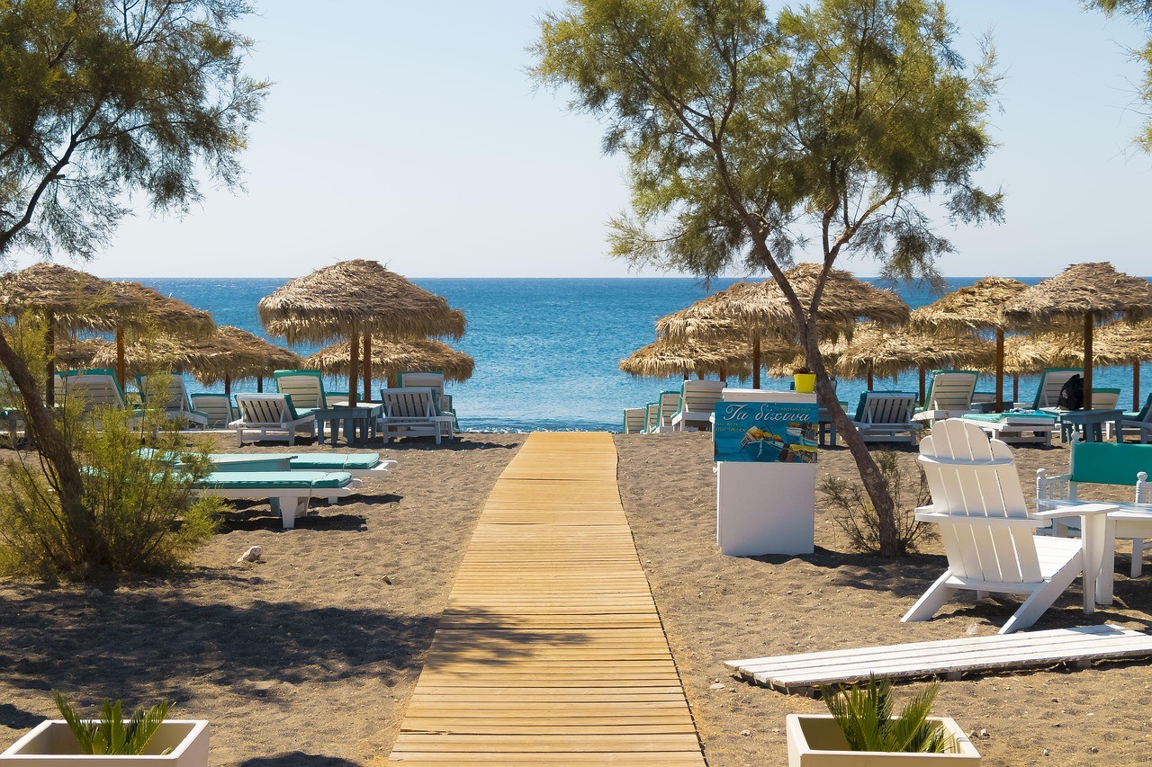 brown wooden beach lounge chair on beach during daytime
