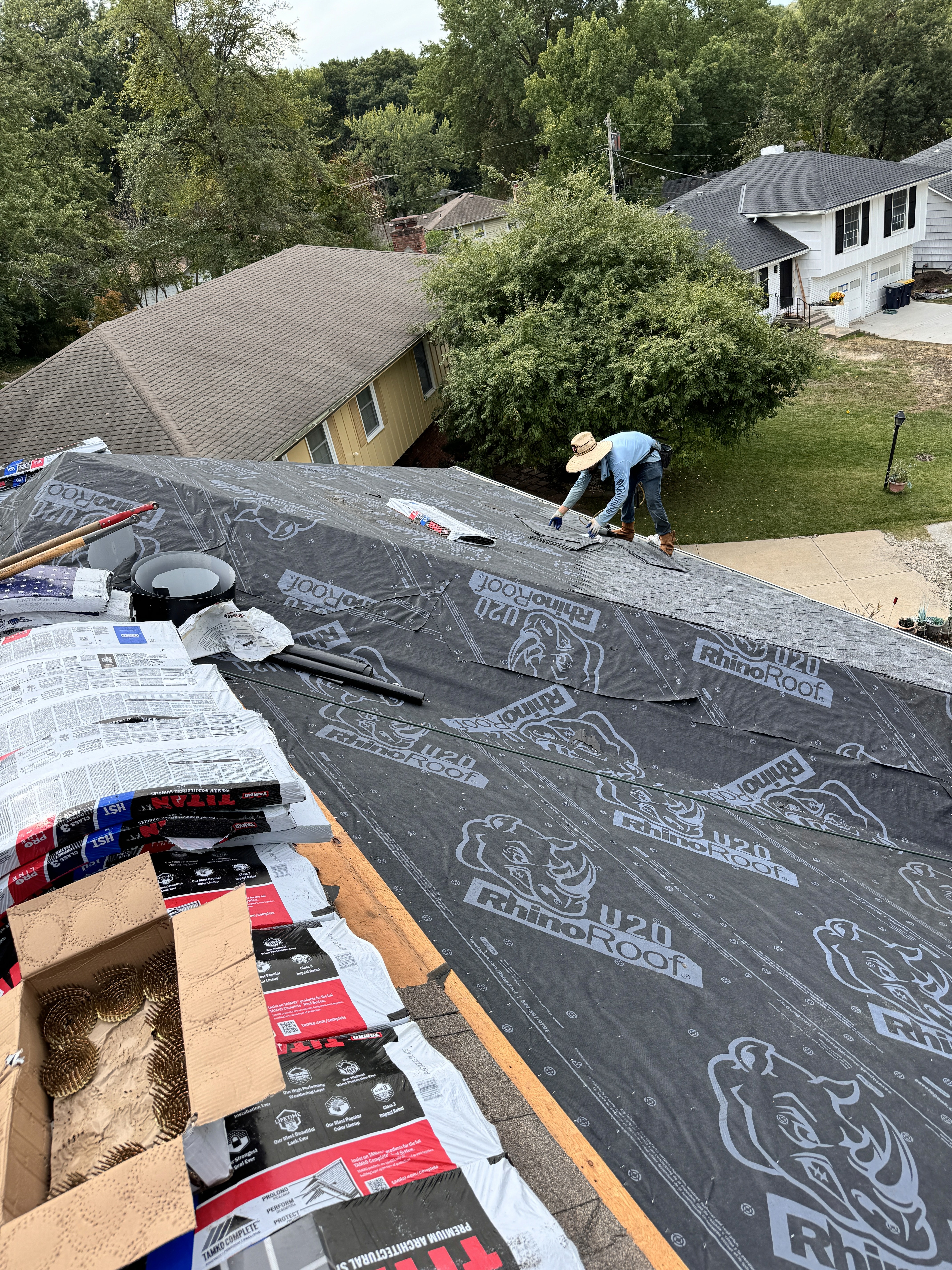 Installing underlayment on roof deck on home in Kansas City, Missouri