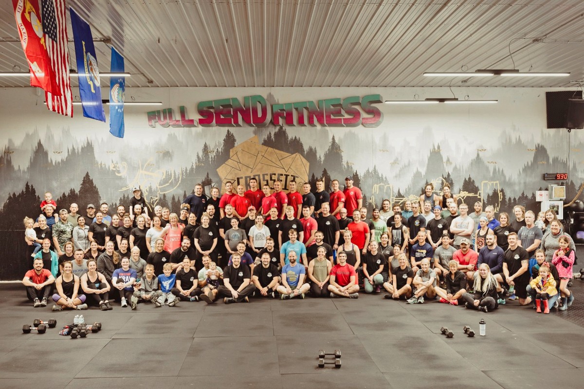 close up picture of a dumbell in a dimly lit workout gym with a blurry background. The dumbbell should be centered on the screen