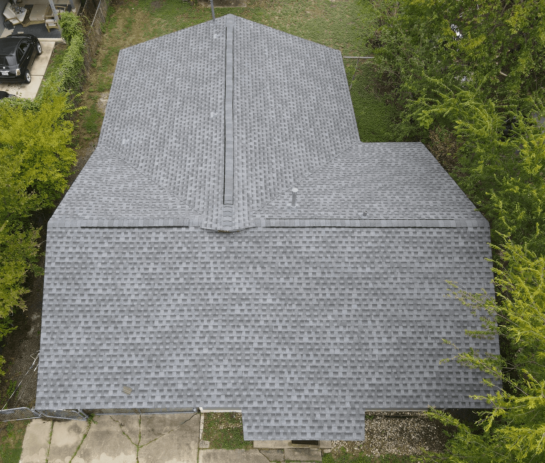 Crossed hip roof with GAF architectural shingles and a ridge vent, combining stylish design and enhanced attic ventilation.