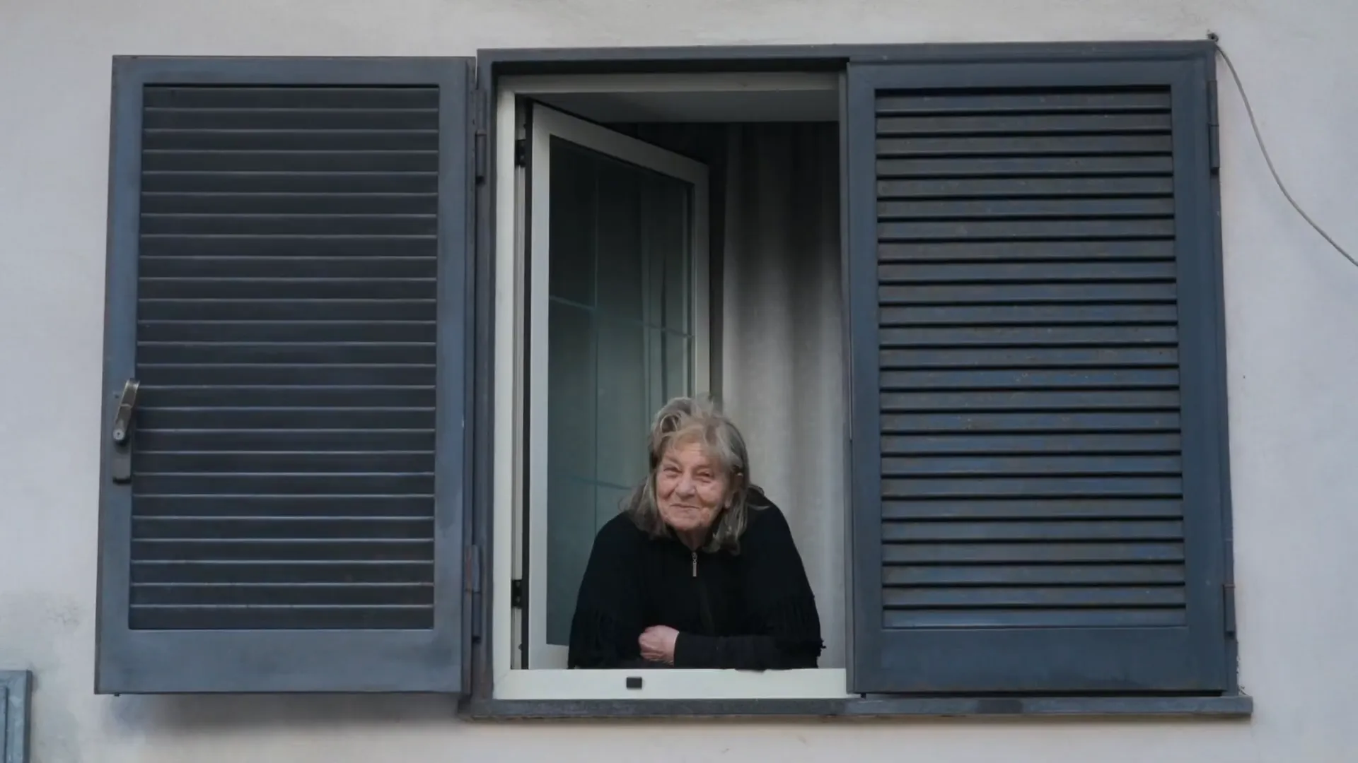 Lady looking out of a blue window