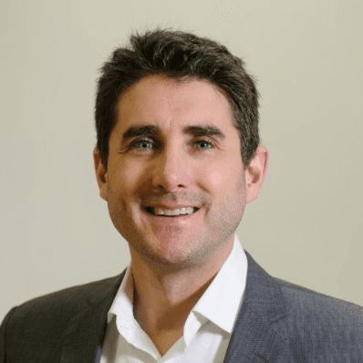 smiling woman wearing white and black pinstriped collared top