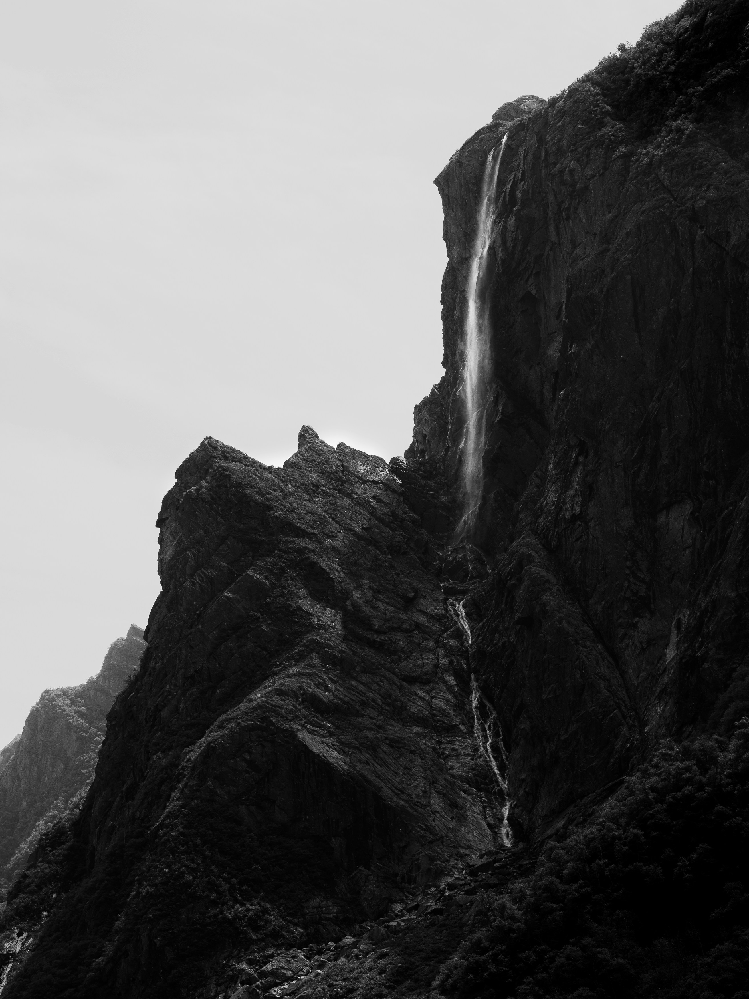 Waterfall cascading down a steep, rocky cliff face.