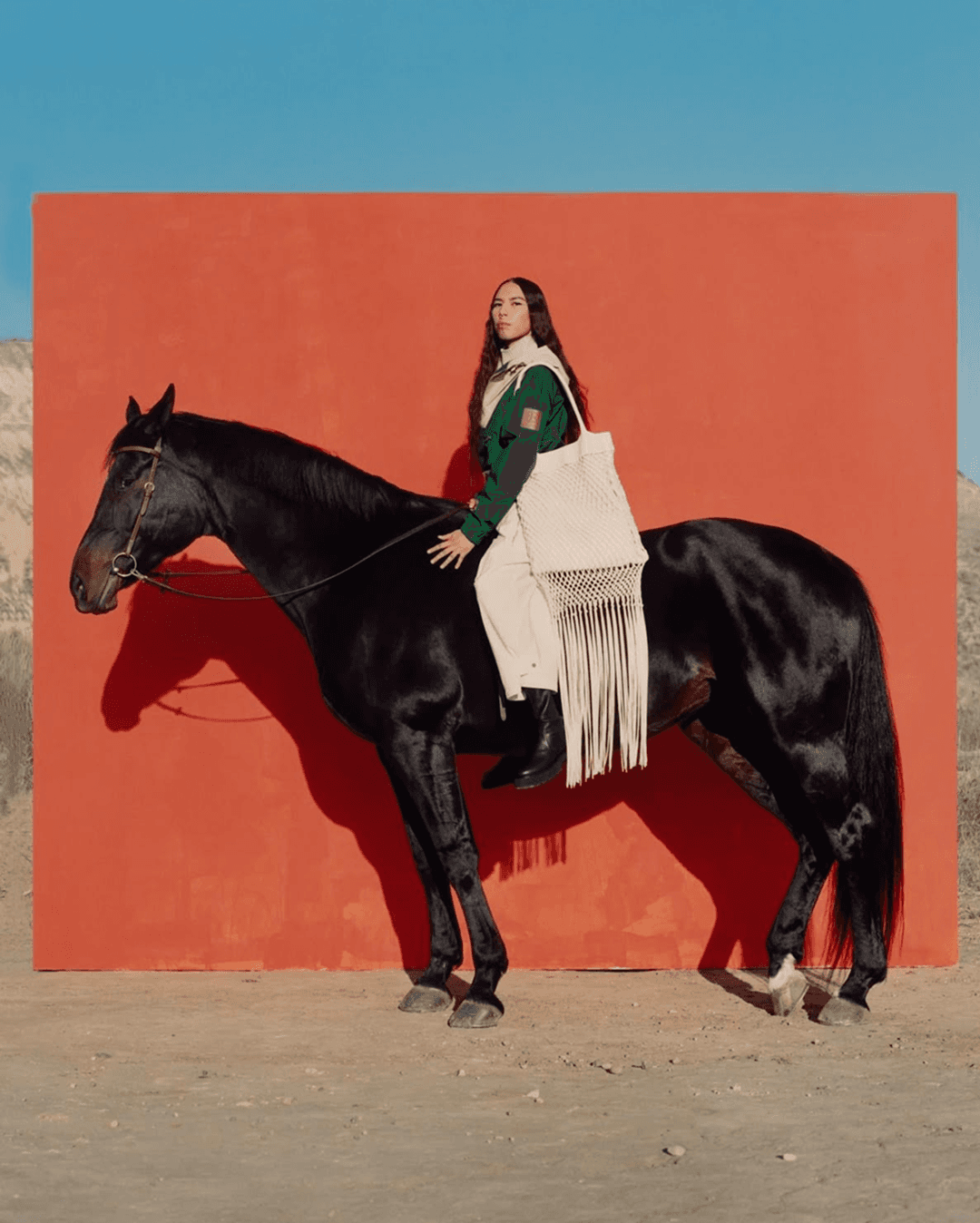 Vintage leatherworking edge creaser tool with a wooden handle resting on a white marble slab, captured in moody studio lighting.