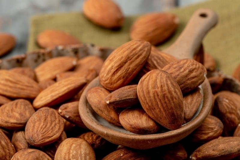 almonds in a wooden spoon