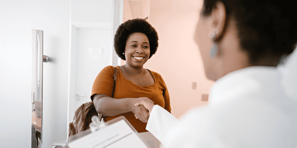 Doctor welcoming the patient and both are smiling