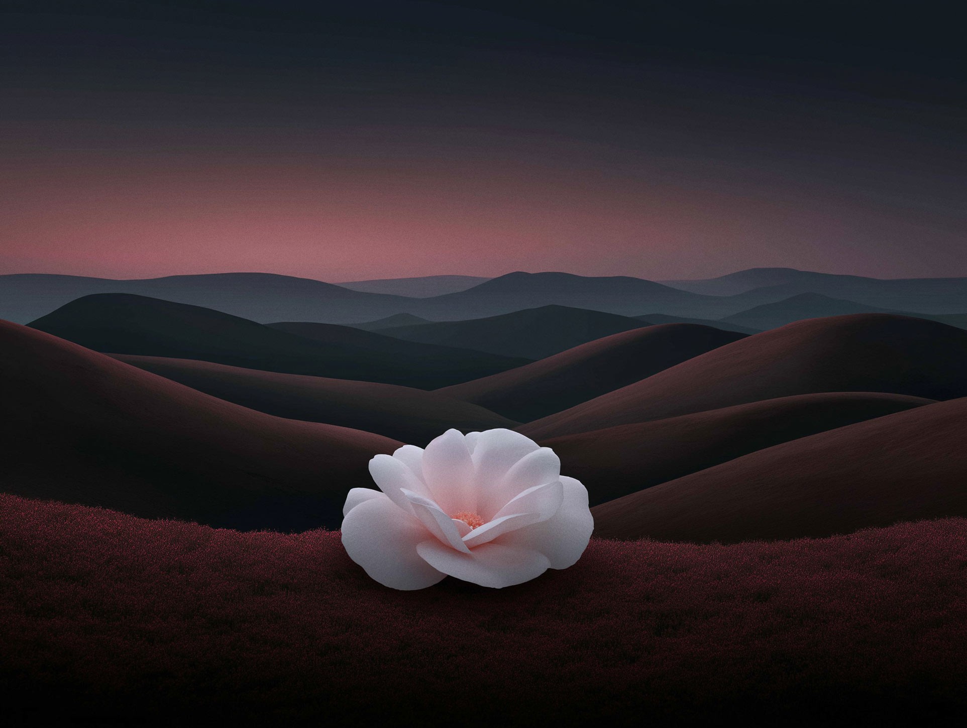 Wide panoramic mountain valley under a gradient sunset sky