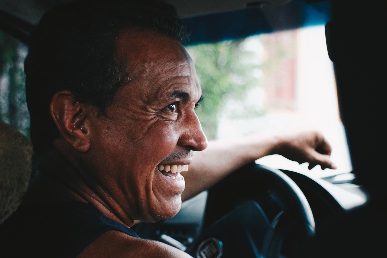 a father smiling in joy in a car, heso blog image