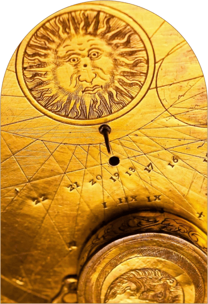 Close-up of a golden mechanical device with intricate designs and a keyhole, showcasing detailed craftsmanship.