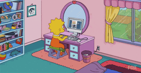 Lisa Simpson sitting by office desk working on the computer