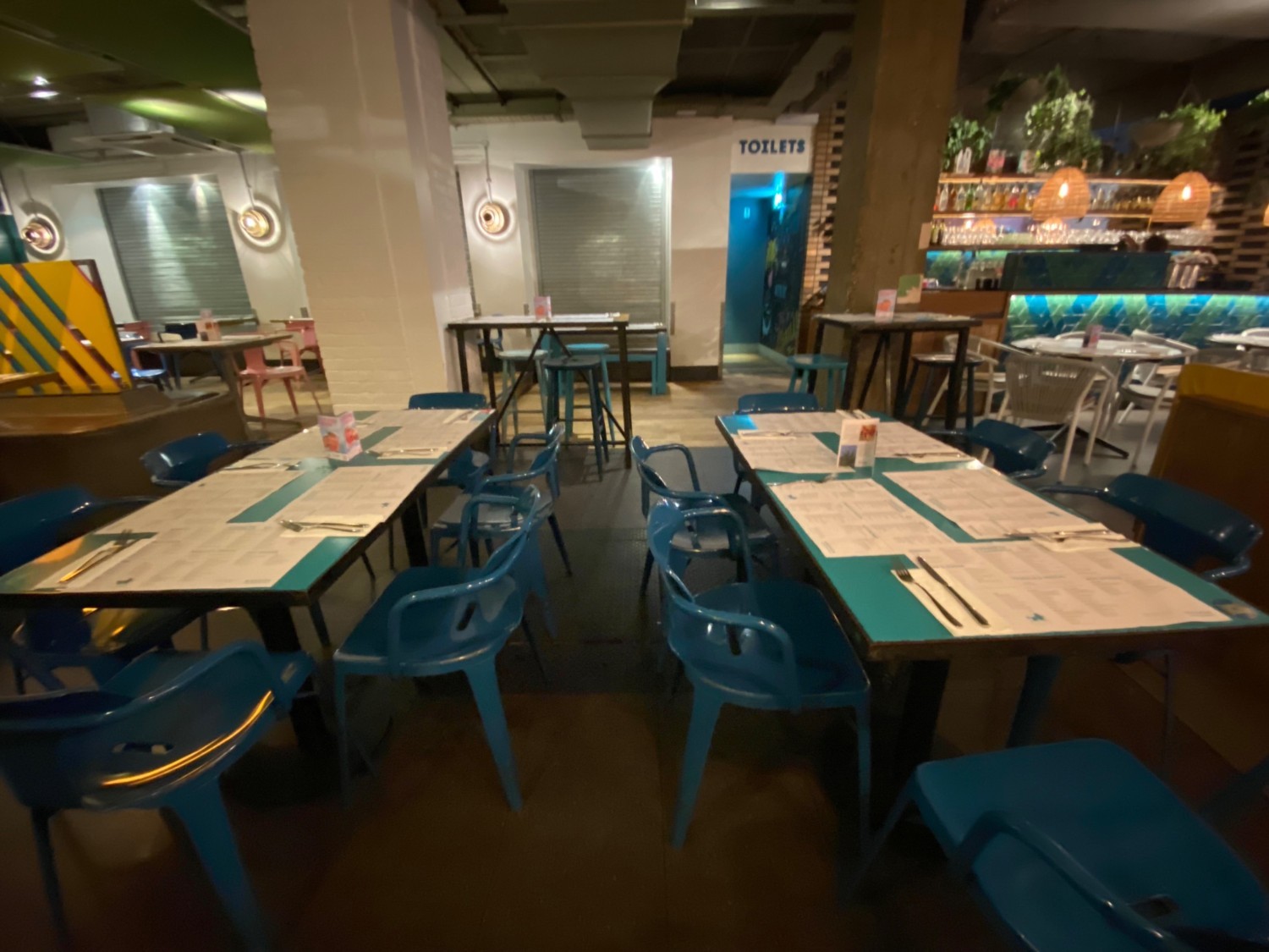 Wahaca seating area. Path straight. Seating either side.