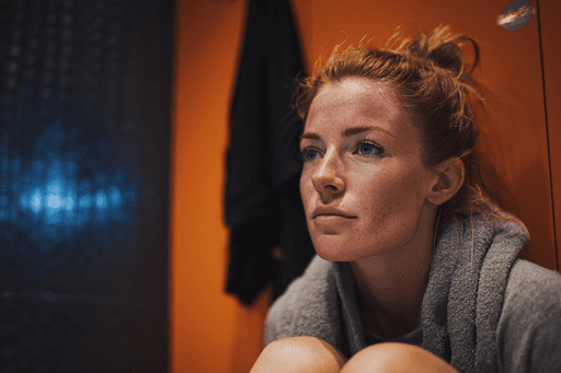 A maroon passport, a credit card, and a document are placed on a dark surface.