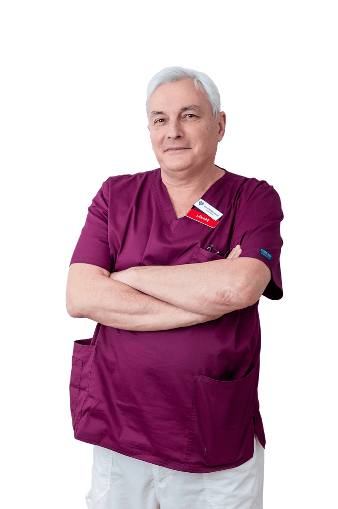 A medical professional smiling and standing in front of the camera