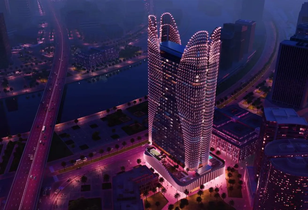 Aerial night view of Binghatti Skyhall with stunning purple lighting and cityscape in Dubai.