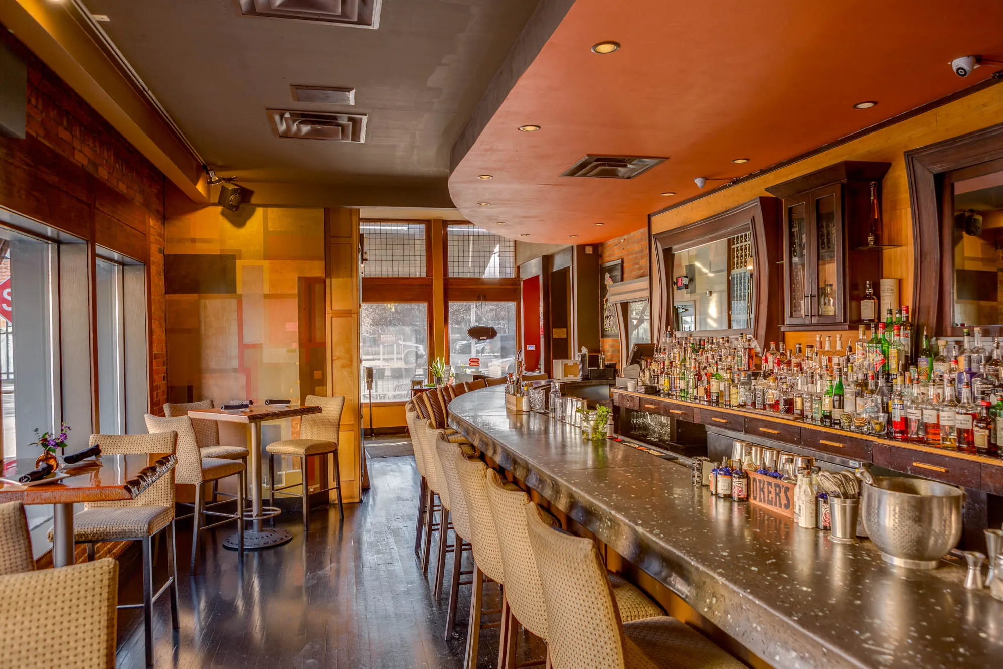 Long bar and dining area with tall windows at Sidebar