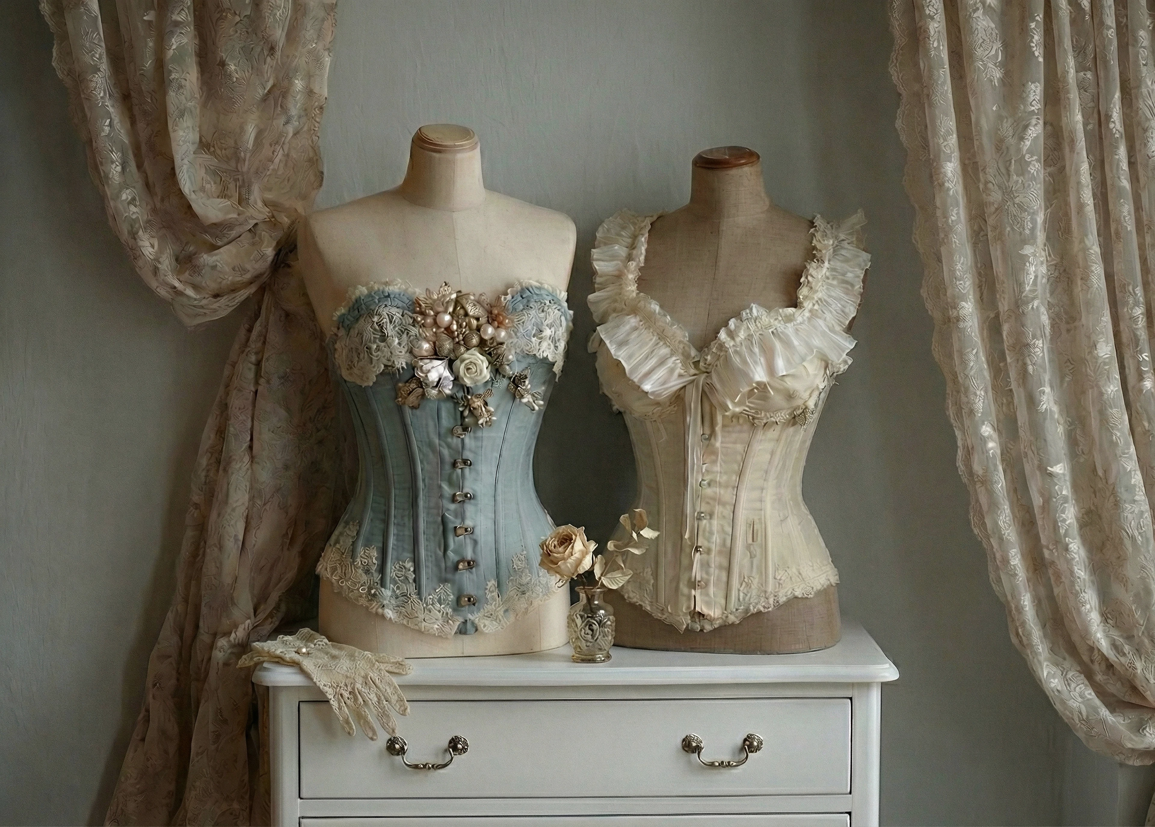 Two historical corsets in bedroom.