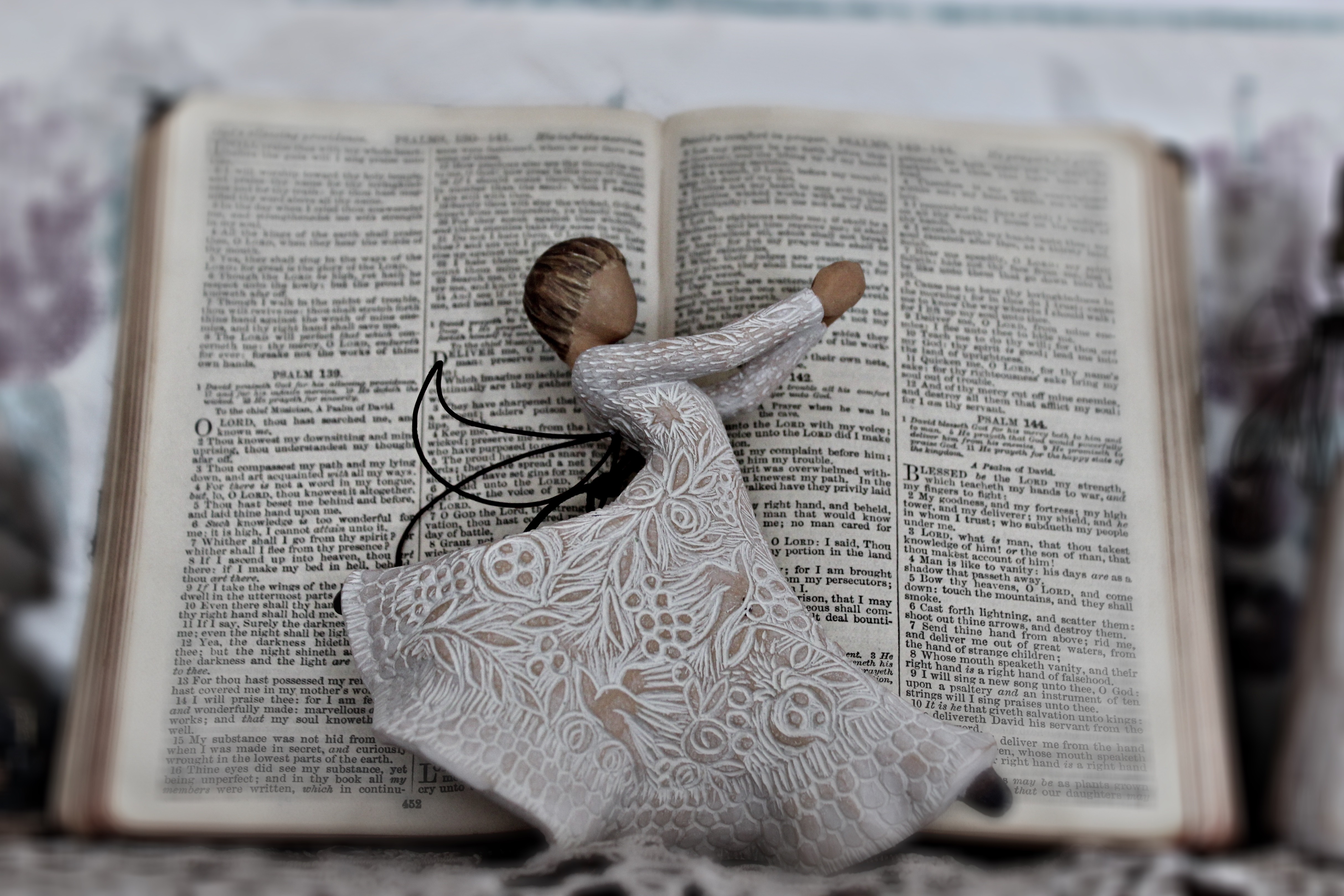 angel ornament against an open Bible