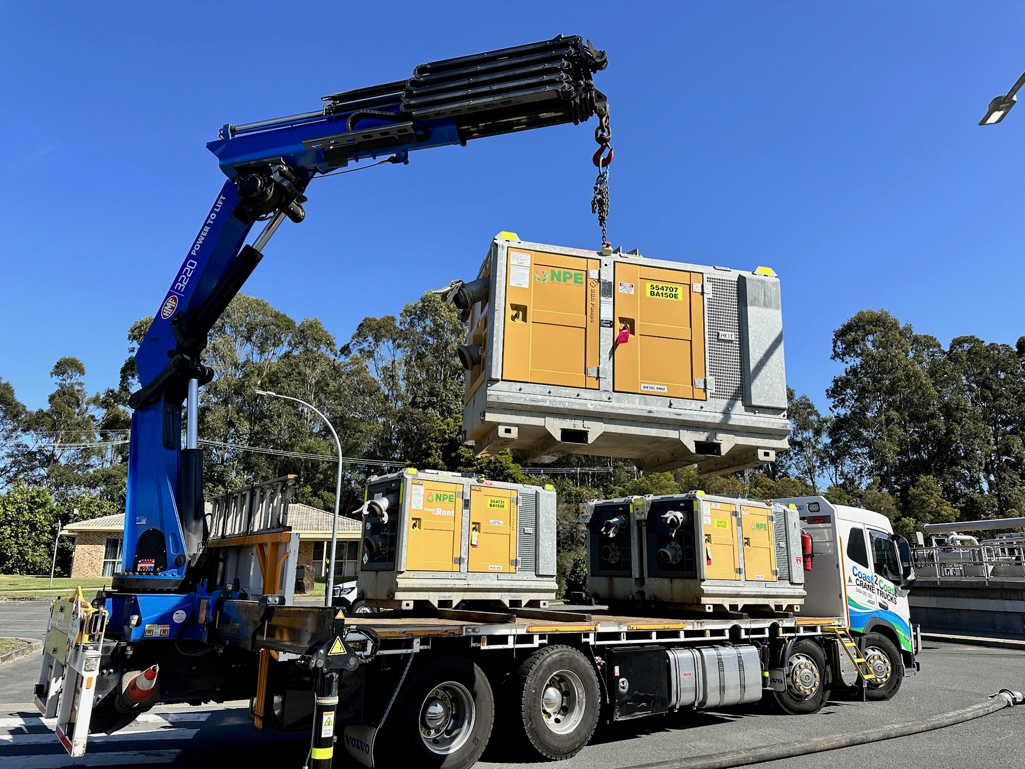 Crane Truck lifting large pumps