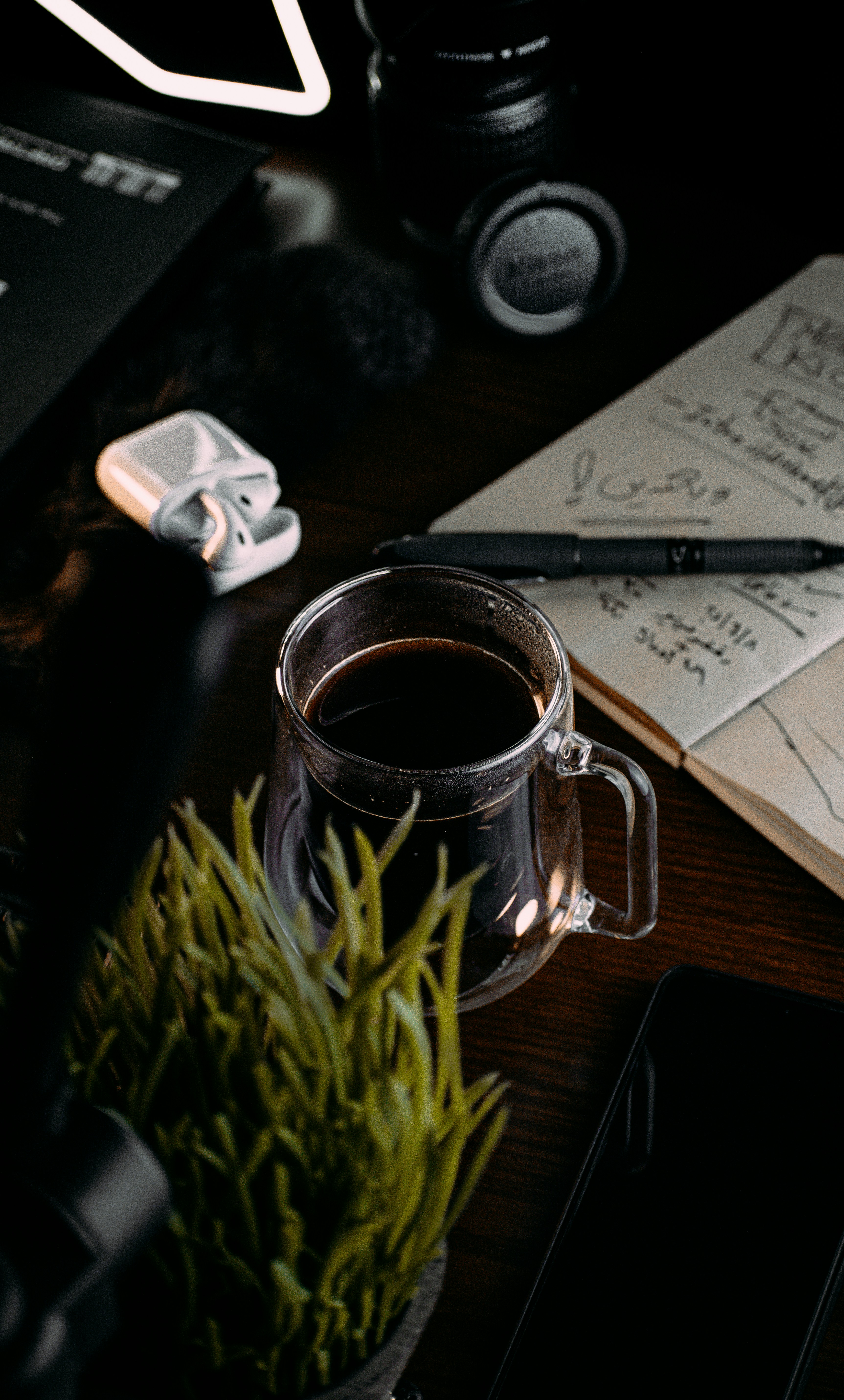 a cup of coffee sitting on top of a wooden table