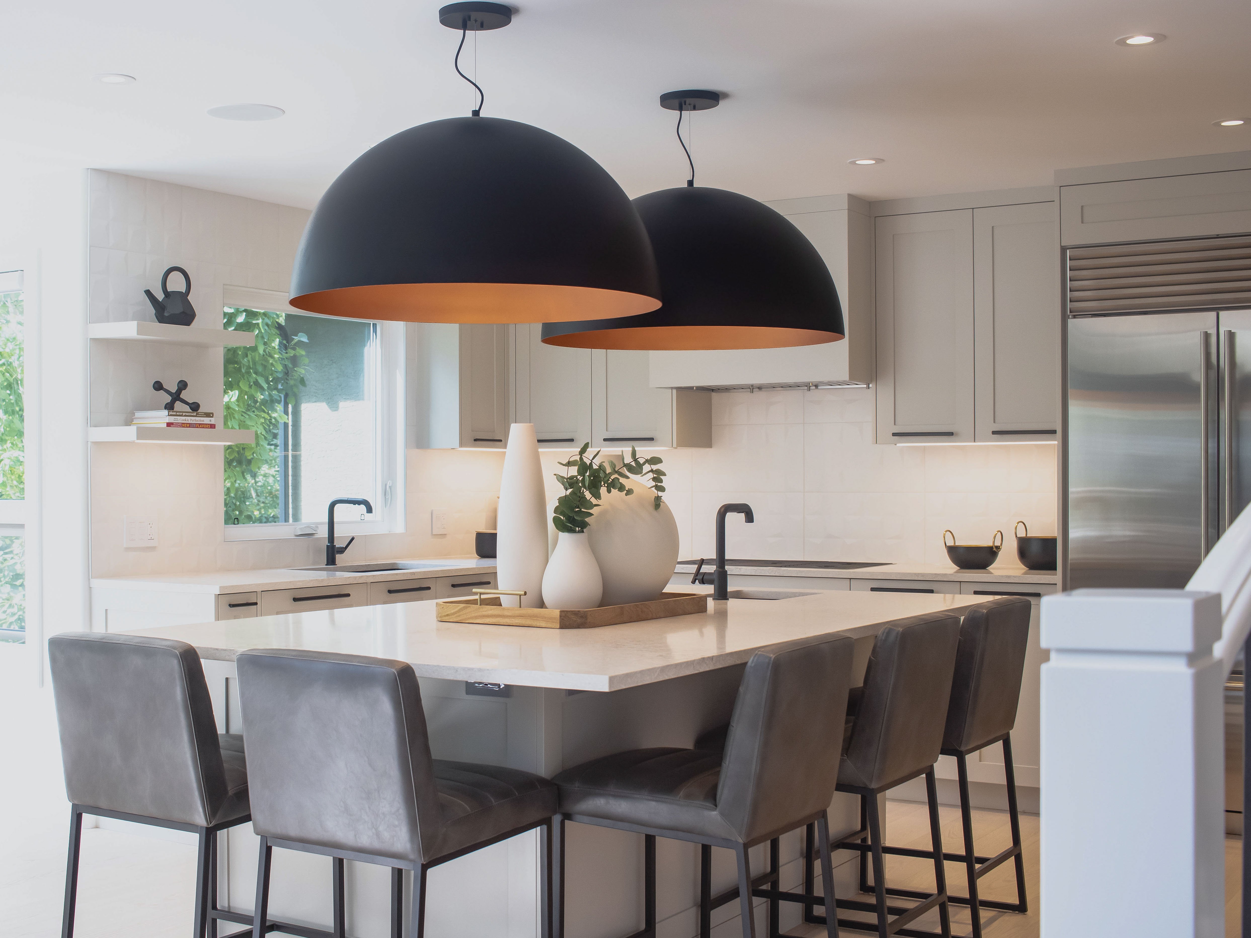 Image of Modern kitchen interior with island seating, pendant lighting, and sleek design by KHD Homes.