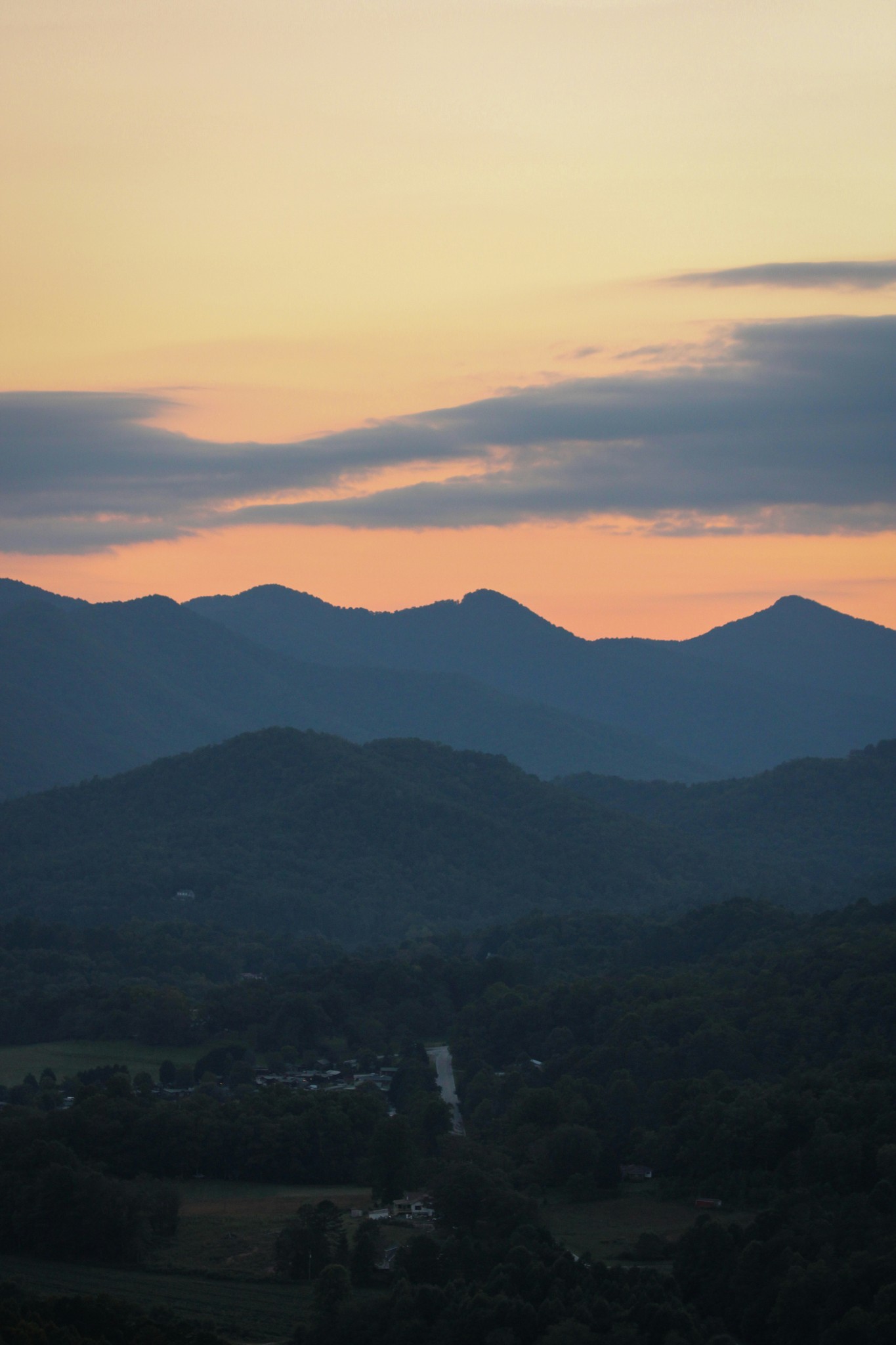 Mountains silhouetted against a colorful sunset sky.