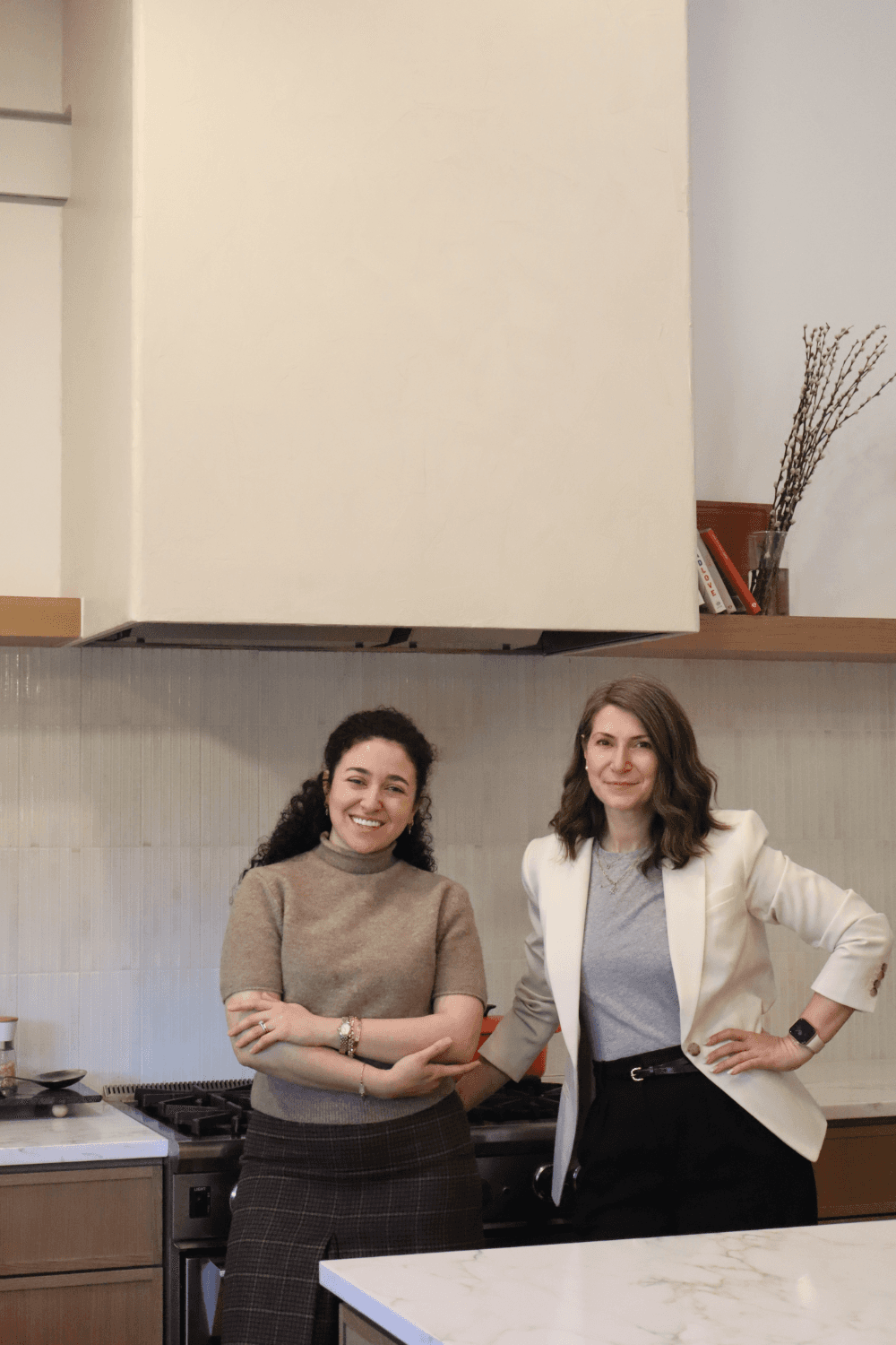 QW Kitchen & Bath design team posing in completed custom white oak kitchen remodel in Austin Texas