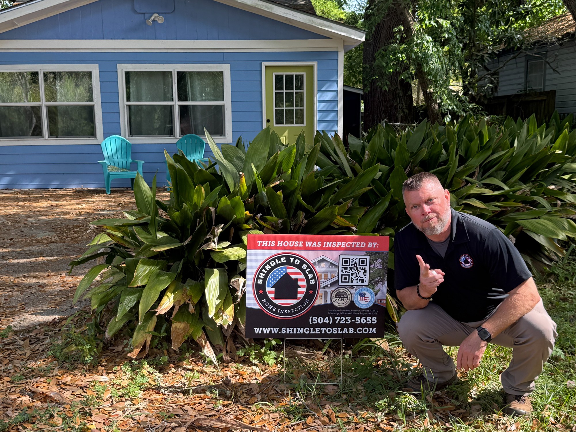 Home inspector in Louisiana with inspection sign outside residential property