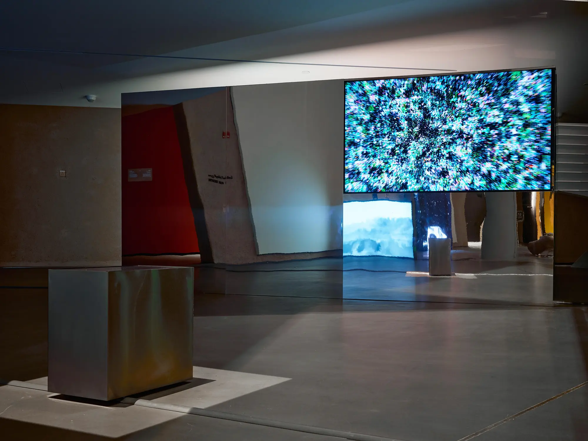 Abstract digital art display with a metal pedestal.