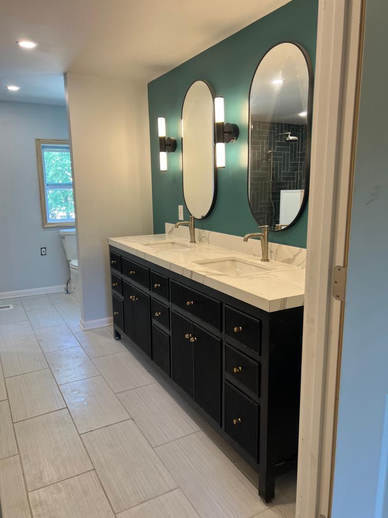 Double vanity Installation and tile flooring in a bathroom remodel.