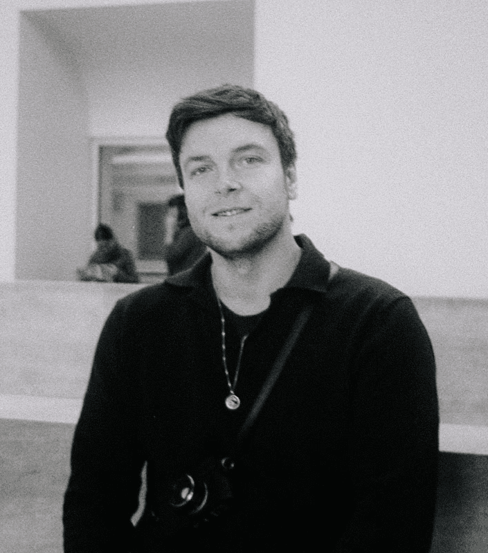 Man wearing white bunny hat with fake glasses and mustache design.