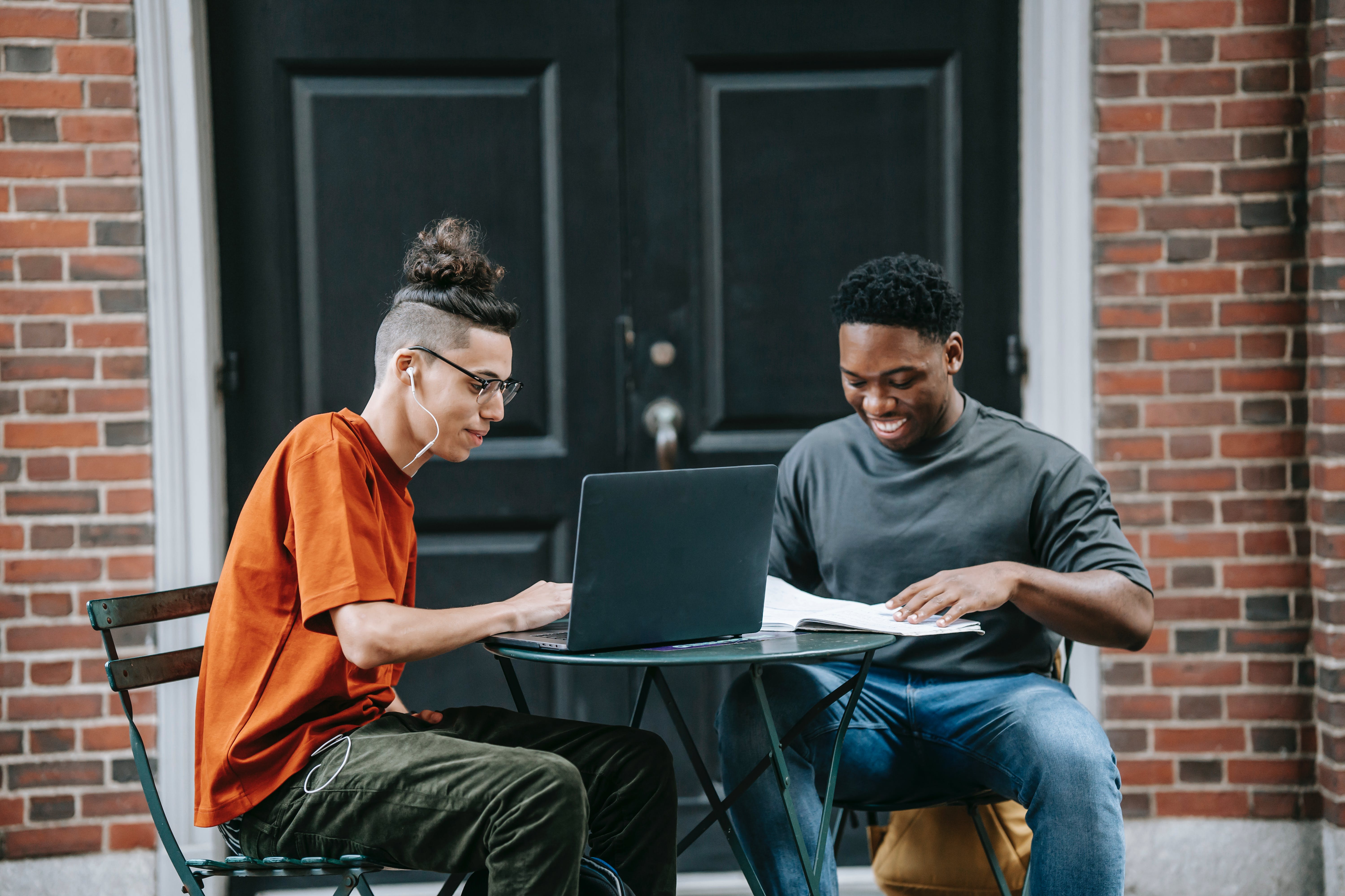 Young men working online on laptop scheduling emails