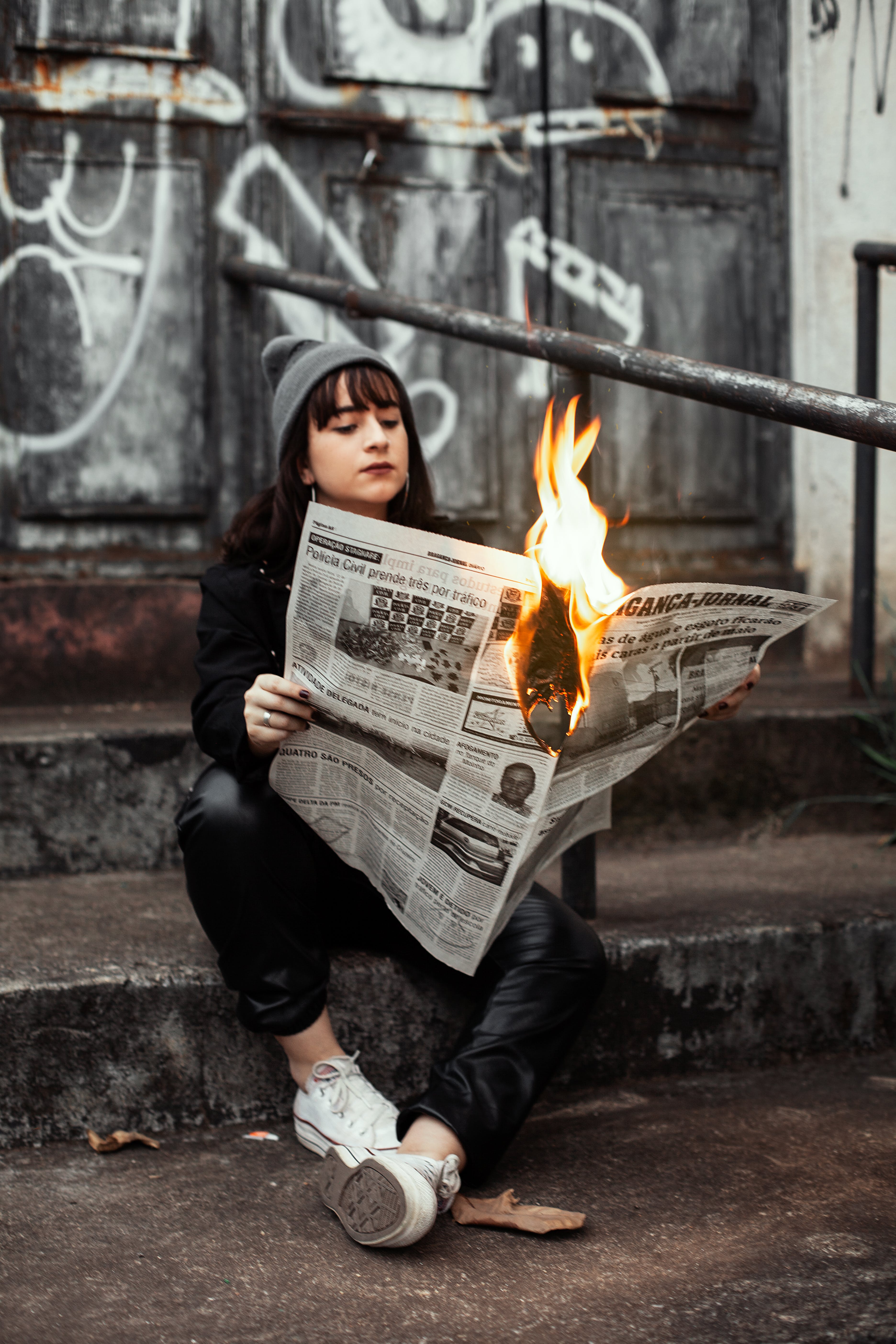 Woman reading a burning magazine symbolizing revolution