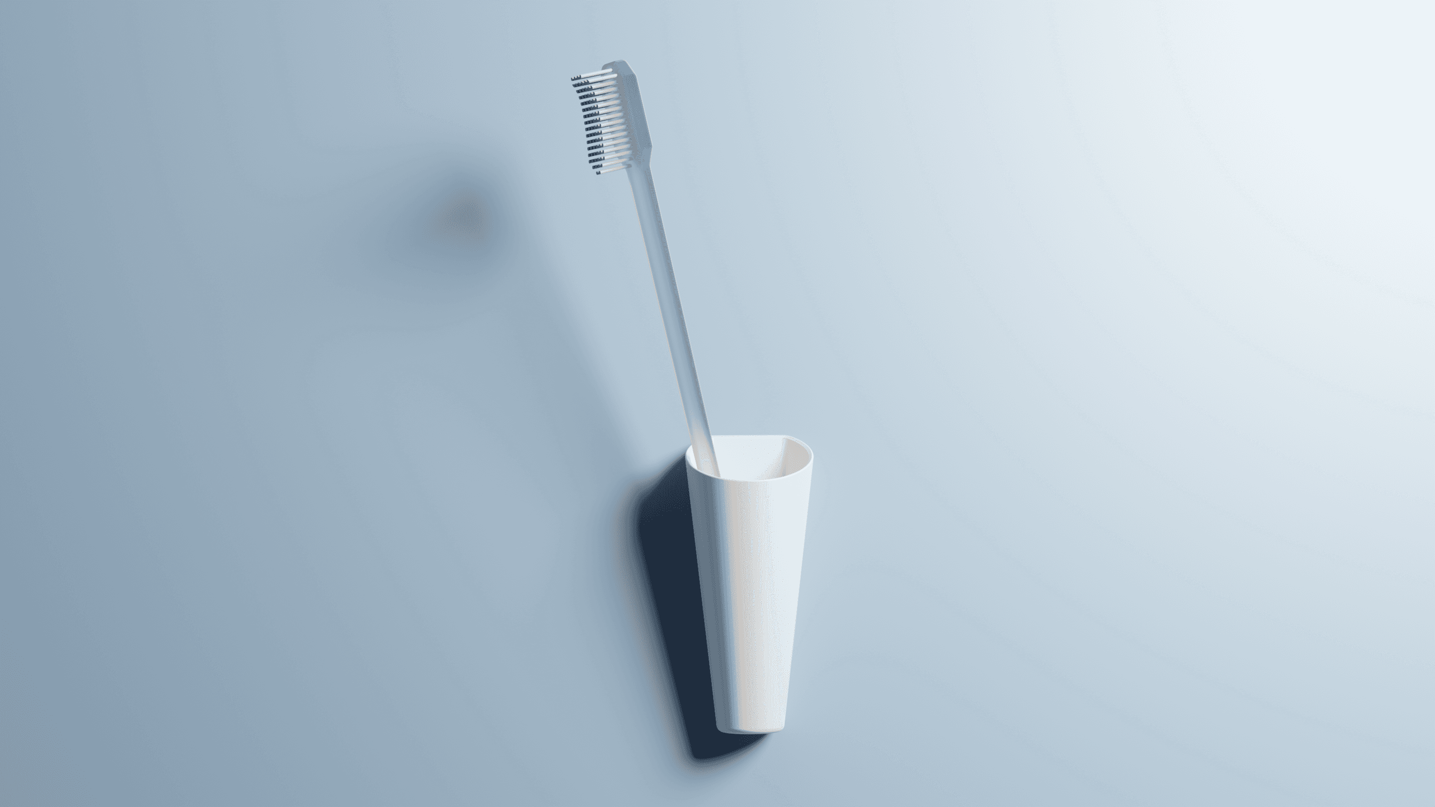 A sleek, cone-shaped white wall-mounted toothbrush holder. This minimalist design is an example of a simple, practical product developed with attention to detail and ease of installation.