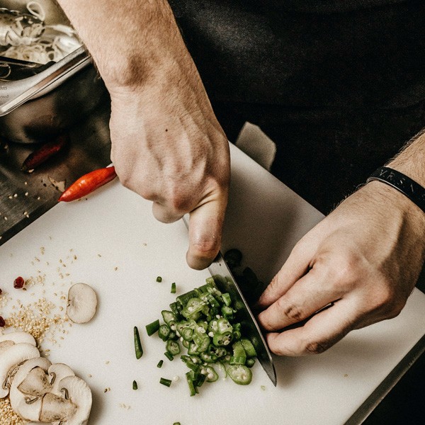 Person chopping vegetables on a cutting board