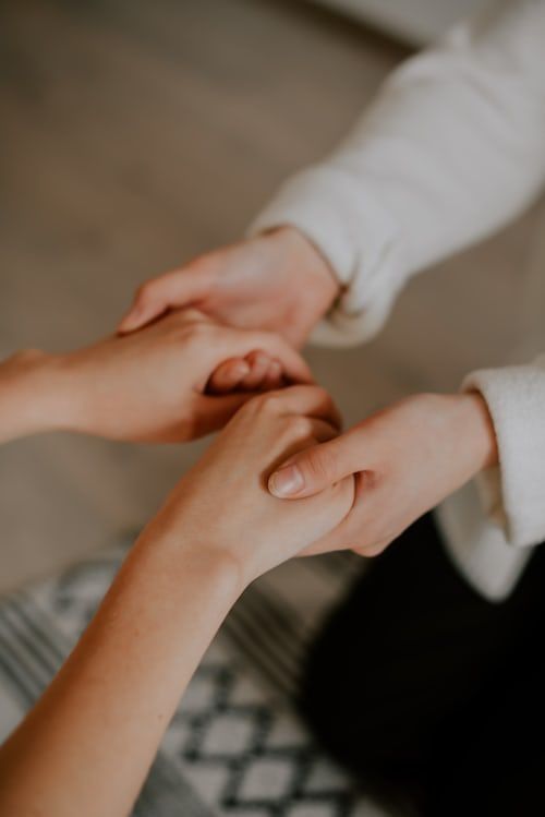 Two people stretching on yoga mats