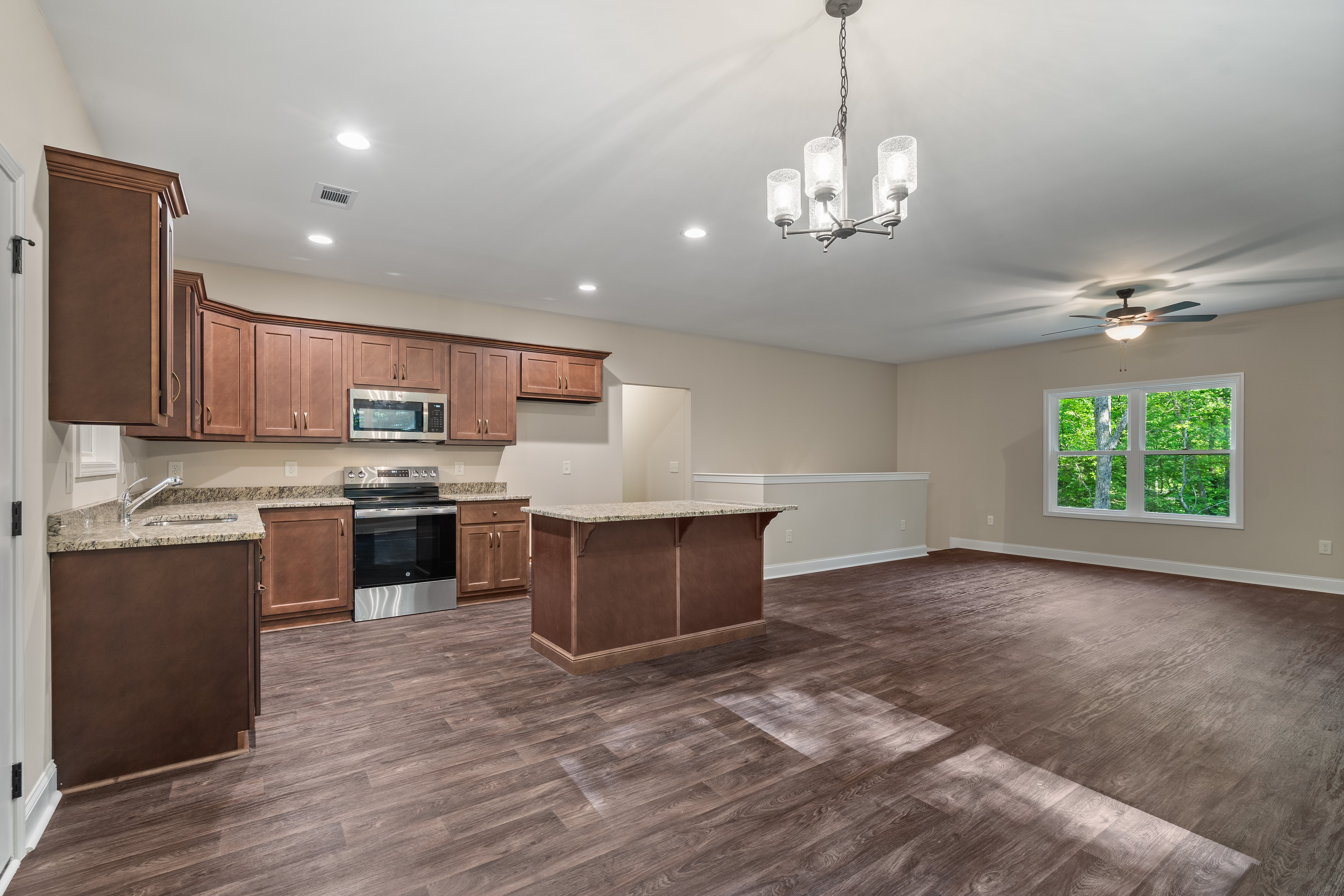 Spacious master bedroom with vaulted ceilings and hardwood floors