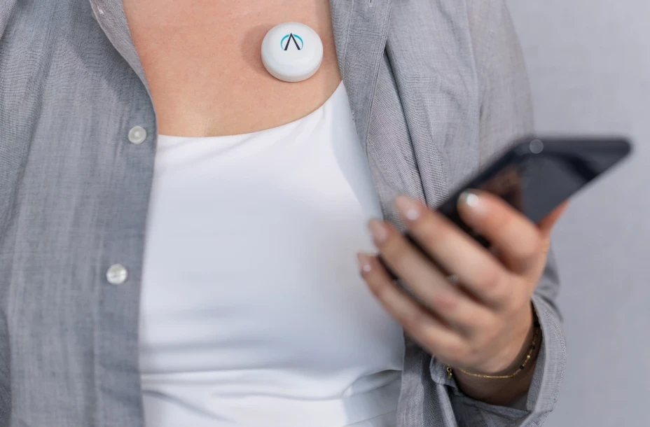 PneumoWave wearable respiratory monitoring sensor attached to patient chest, demonstrating connected health technology and remote monitoring.