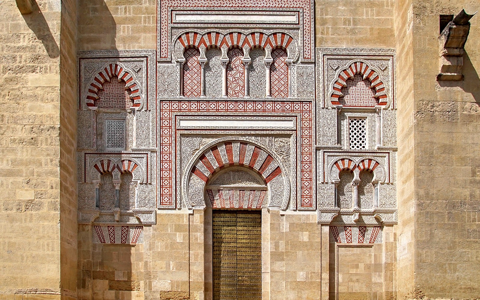 Entrance of the Cordoba Mosque-Cathedral with intricate arches and geometric patterns.
